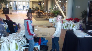 Our fearless leader Julie's son and a past member's nephew helping at Keepsacks for Kids!